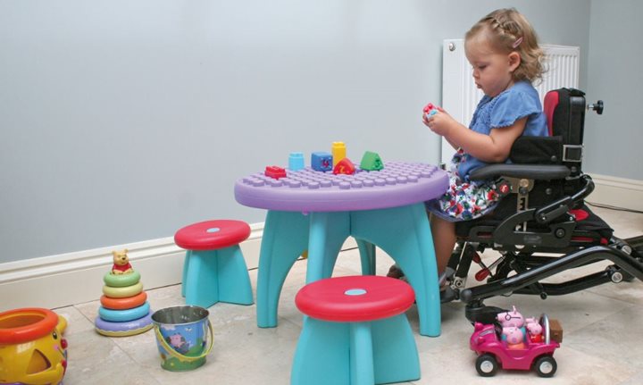 A young child with a disability playing
