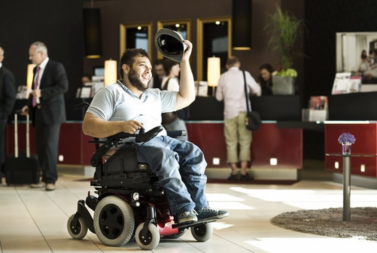 A tourist using a wheelchair in a hotel