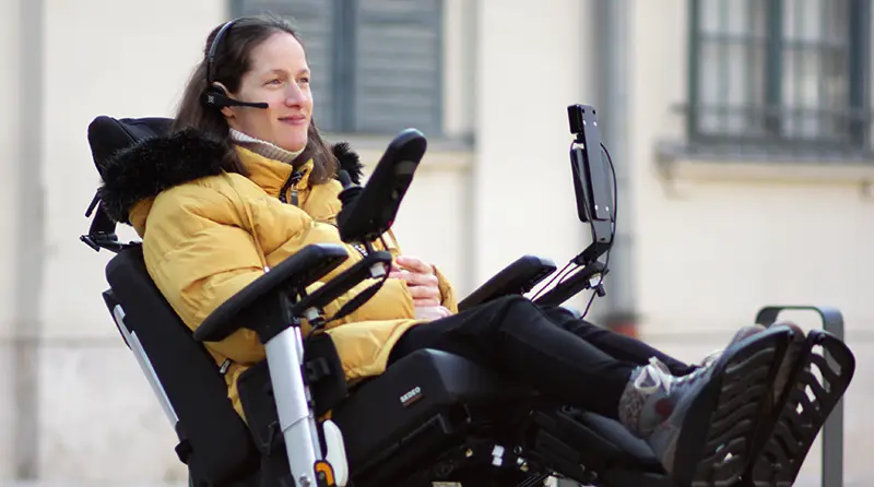 A woman using a Switch-It Vigo to control her power wheelchair