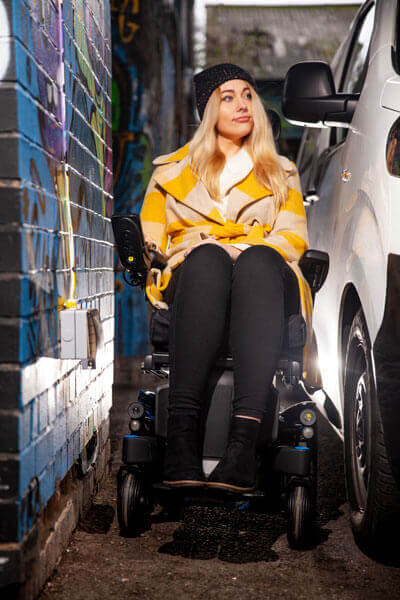 A young woman using her power wheelchair