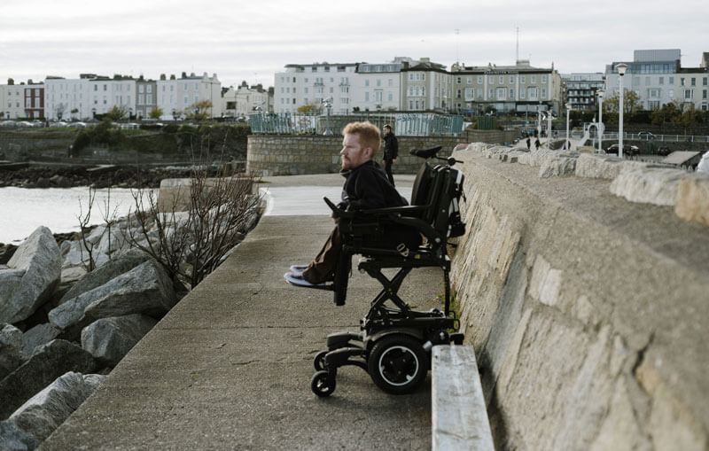 Kevan outside using his power wheelchair