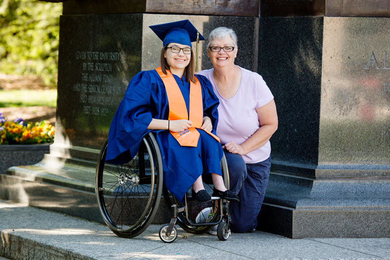 A University of Illinois graduate with her mother at the Alma Mater sculpture, a well-known icon of the university campus.