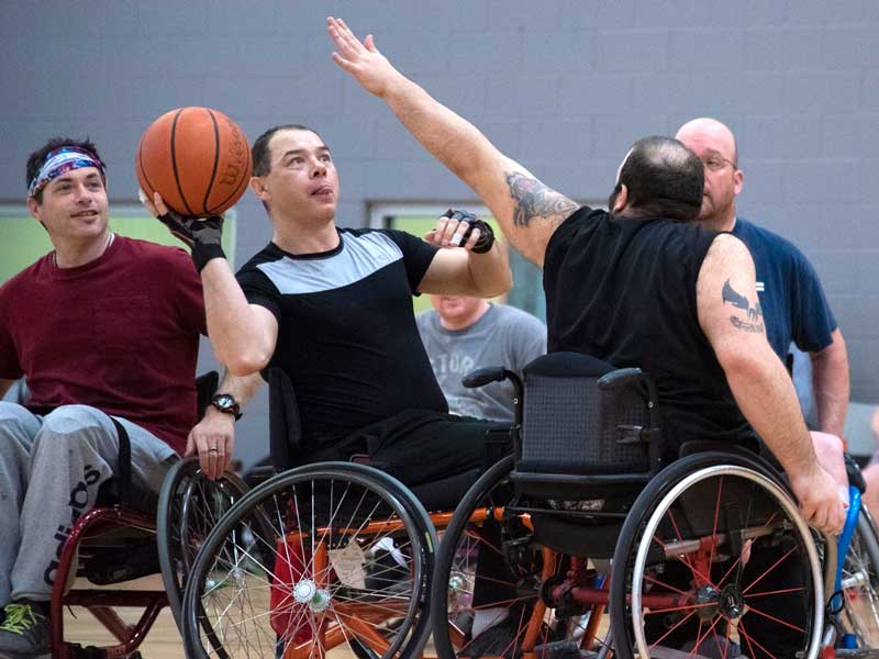 A wheelchair basketball player lining up a shot