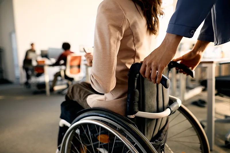 A woman in a wheelchair being pushed