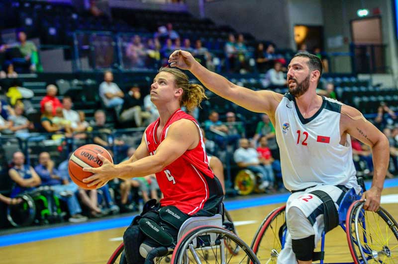 Nik competing in wheelchair basketball