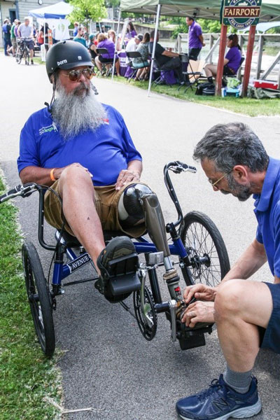 Guest gets adjustments made to his cycle before setting off down the Erie Canal.
