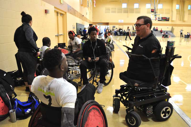 Kyle speaks with some of the wheelchair rugby players