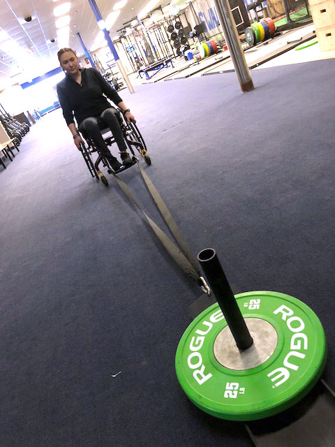 Jess pulling weights with her wheelchair