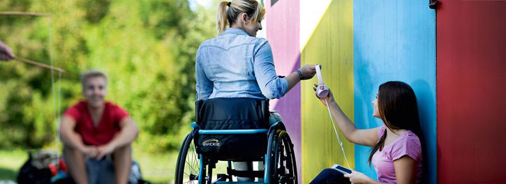 A woman in a wheelchair with her friends