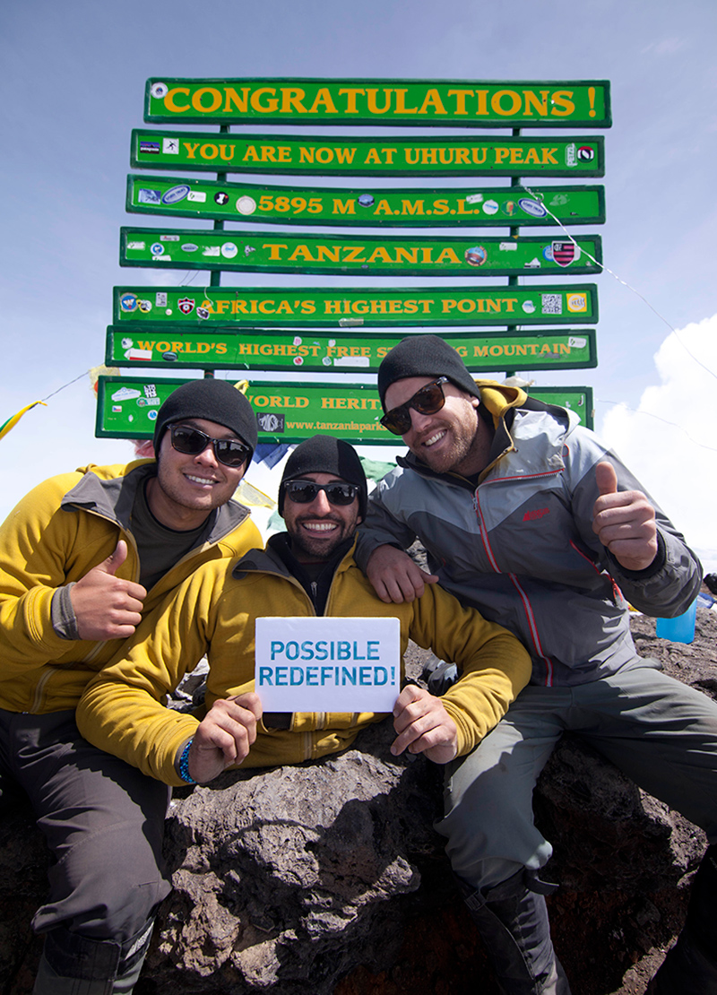 Spencer West with friends at the summit of Mt. Kilimanjaro