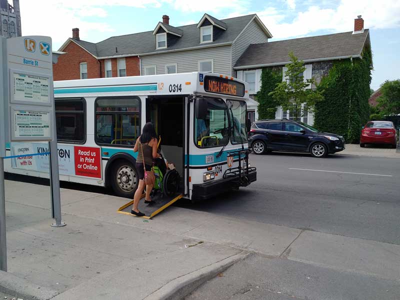 A rider in a wheelchair boards an accessible bus