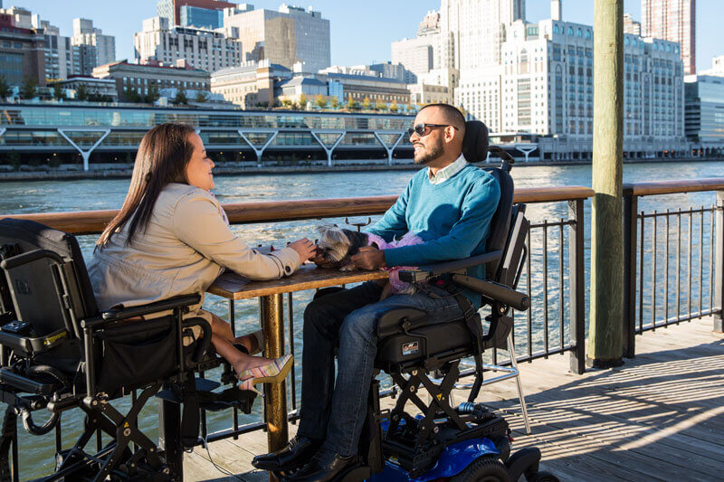 A couple using wheelchairs to enjoy the outdoors