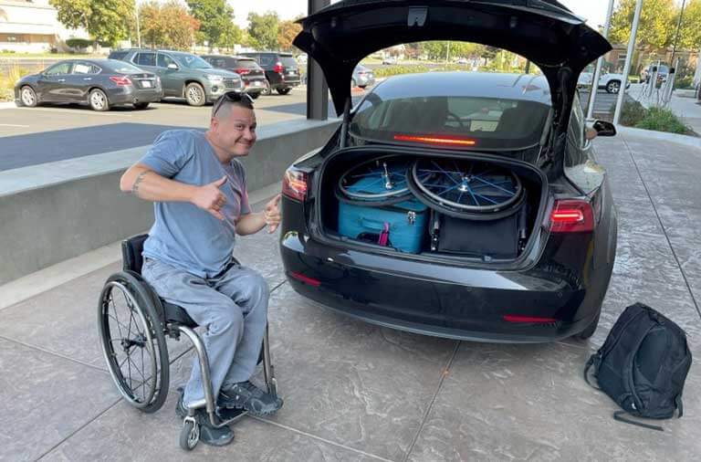 Shaun's luggage and second wheelchair packed into the back of a sedan